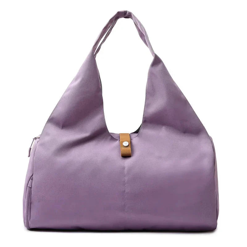 Purple handbag with a brown strap on a white background