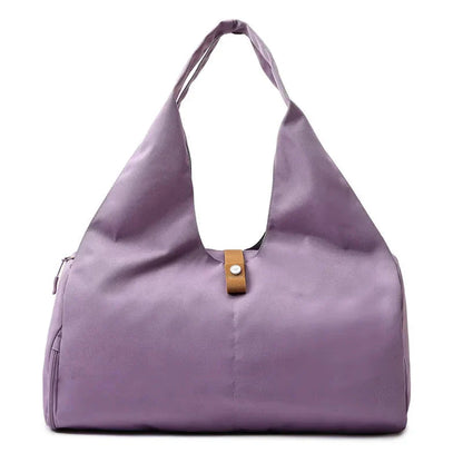 Purple handbag with a brown strap on a white background